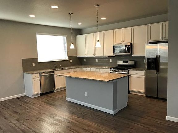Kitchen with extended sink wall & window lets in lots of light