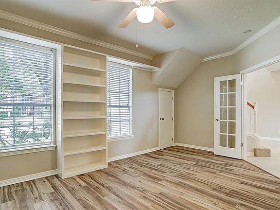 Nice study with French doors, built-in bookcase and closet. Light and bright with wood look tile flooring and neutral walls. Perfect for your home office!