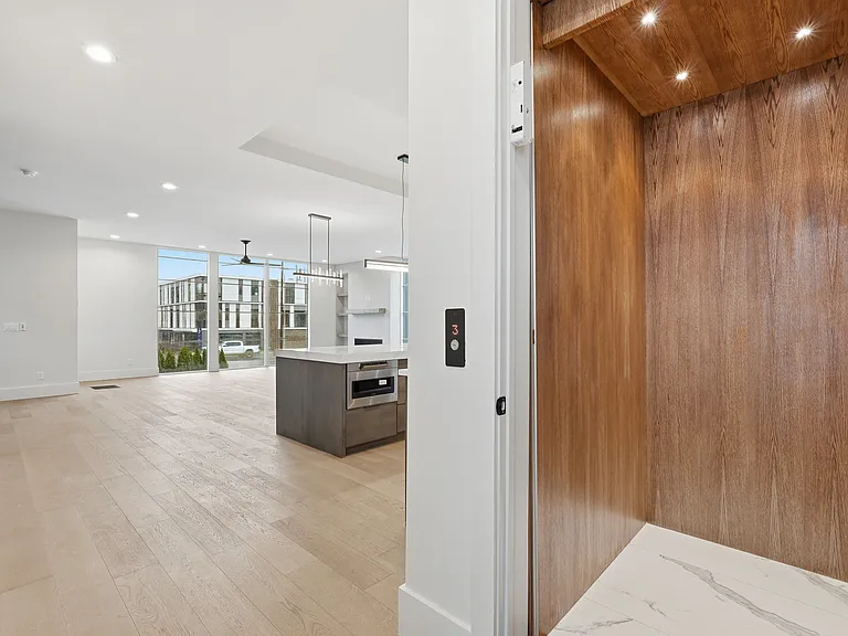 Private in home elevator with warm wood finishes, offering convenient access to all levels.