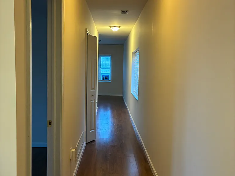 Hall from kitchen, past 2 bedrooms and into living room