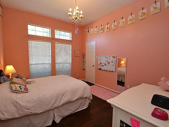 One of 3 secondary bedrooms offering hardwood floors, raised ceilings, two inch window blinds and wa