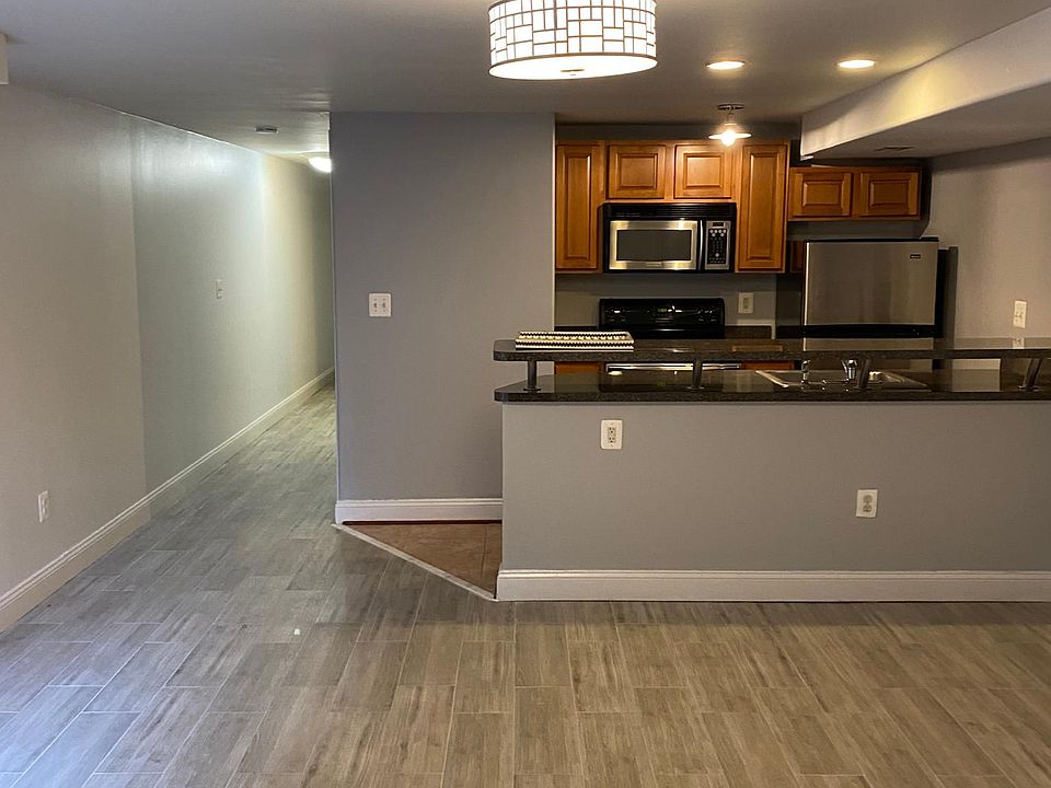 Open living space (family room) with hallway and kitchen view