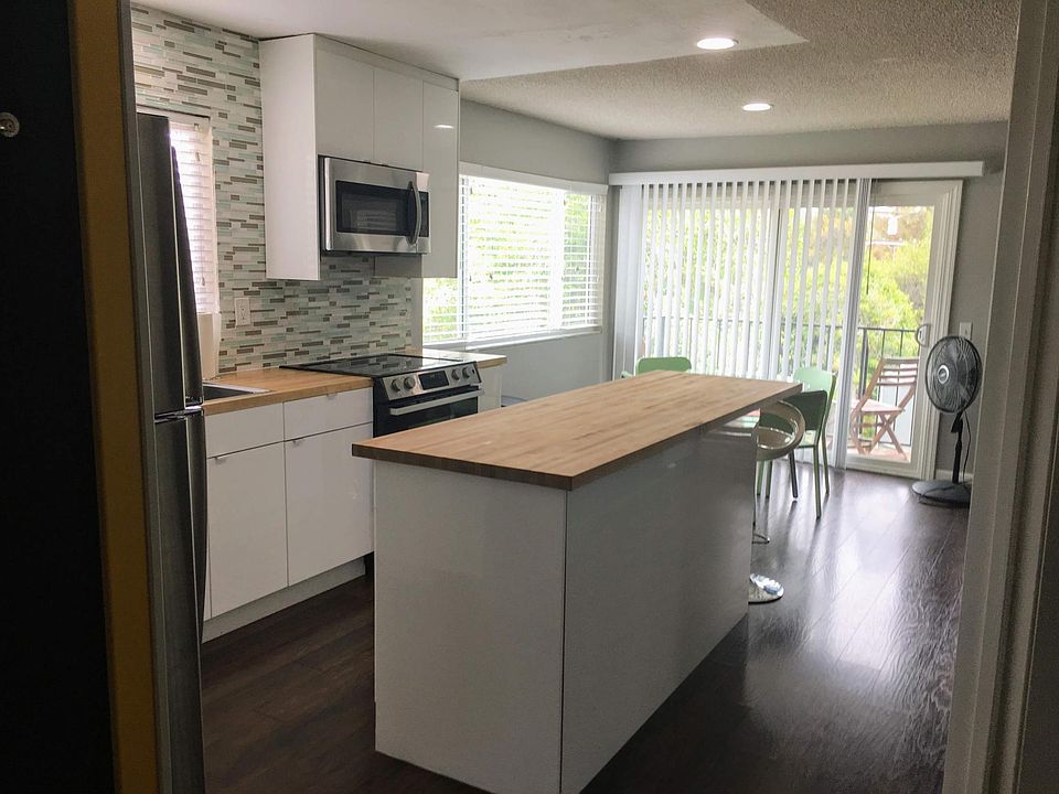 Upstairs kitchen is open to the living room and dining room