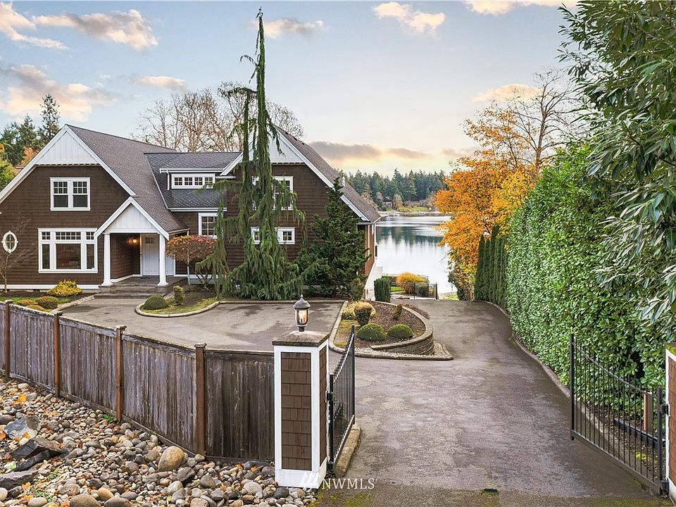 Immaculate Gravelly Lake Home - private dock and boat ramp  - double gated entry - primary suite on the main level.
