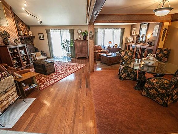 The open concept main level covered with Harto Tellico square edge oak flooring connects the great room with the dining room and kitchen.