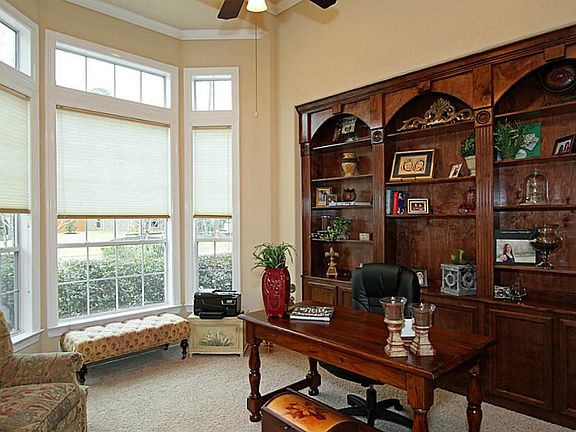 Glass french doors open into the study where you will appreciate expansive windows.