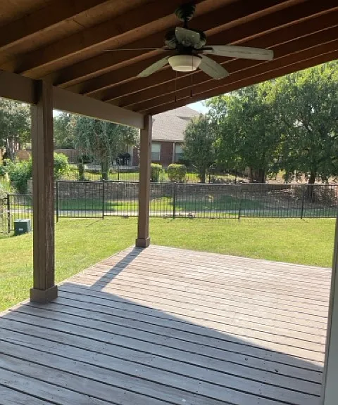 Covered deck with ceiling fan.