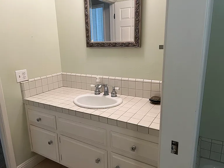 Half Bath --Master Bath is through a pocket door with tub & walk-in shower--Photos soon as we are still painting and replacing flooring tile!