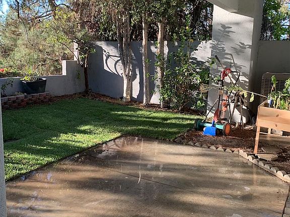 Back yard area with real grass and gardening space.