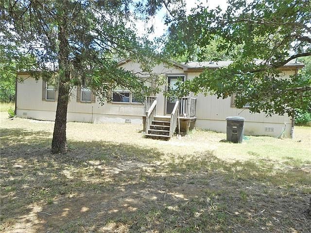 Front of home. Parking is to the right. There is another side entrance to the left.