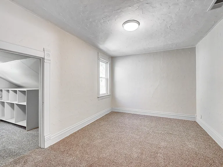 Spacious primary closet! Curtain rod inside allows clutter to be concealed