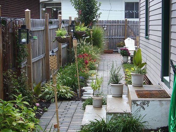paver walk way through manicured side yard