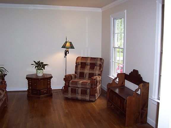 Formal living room with hardwood floors and crown moulding