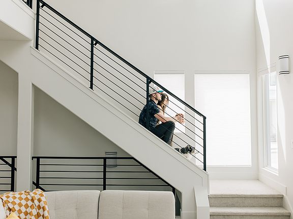 A man and woman sitting on a staircase.
