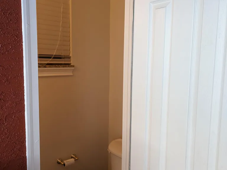 Poolside half-bath toilet precludes the need to enter the home from the pool area to access a restroom.