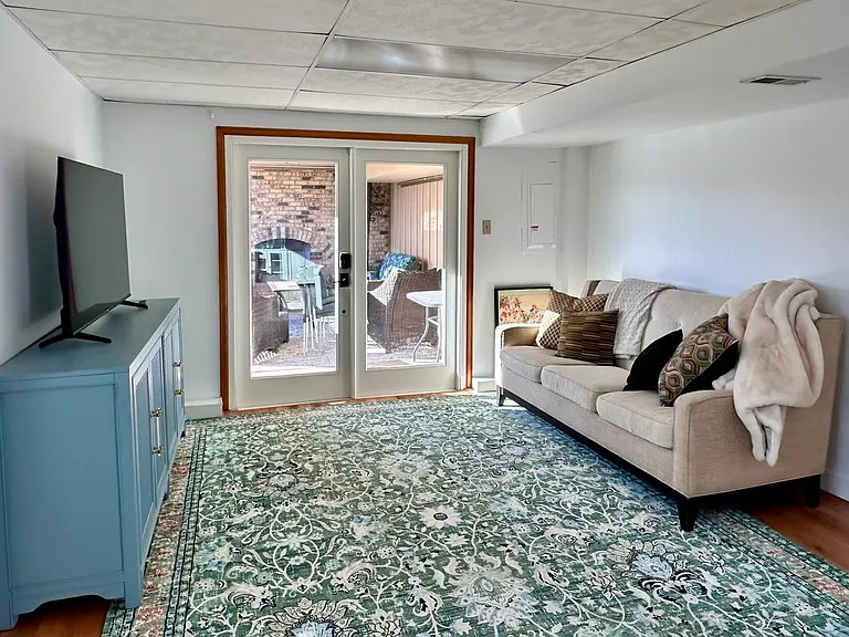 50" Smart TV in living room. French doors to covered patio.