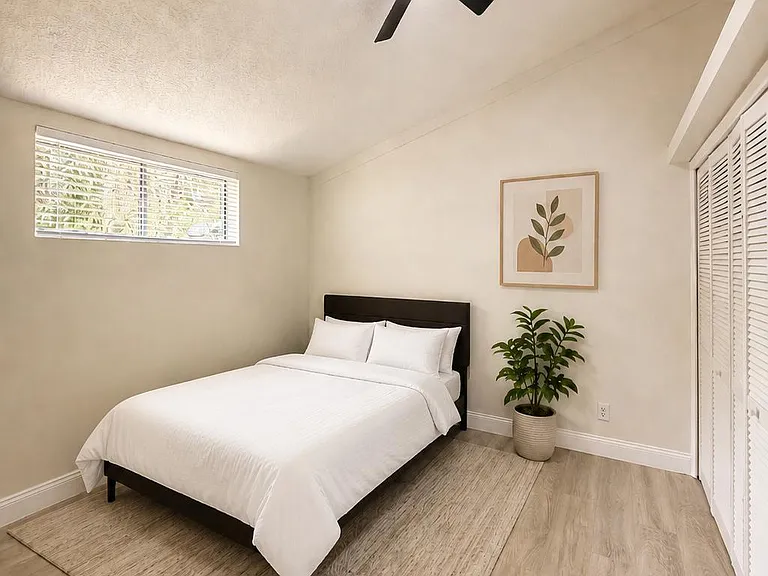 Private bedroom with a ceiling fan, hardwood-style floors, and a closet for storage.