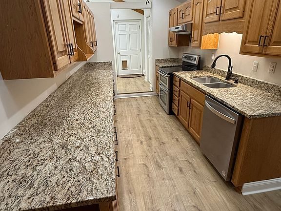 Gally Kitchen with appliances. Leads to cozy breakfast nook.
