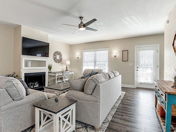 Living room area is open with plenty of seating along with desk working area for those who work remotely! Patio door next to living room to enjoy as well.