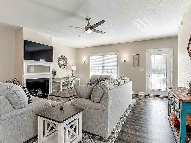 Living room area is open with plenty of seating along with desk working area for those who work remotely! Patio door next to living room to enjoy as well.