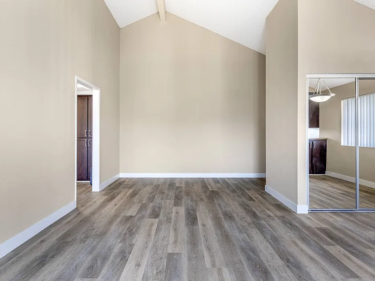 Welcome to Independence Plaza: Where chic meets space. Discover updated flooring, mirrored storage, and endless possibilities in this inviting living room.
