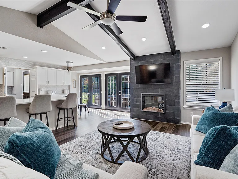 Comfortable main Living Room with Electric Fireplace and Flat Screen TV, Open Concept. Home has Multiple areas to work and relax. Second Living Room at front of the house with workspace.