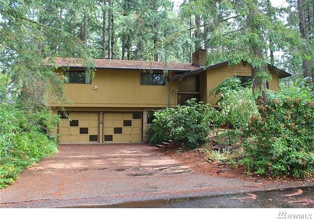 Large home set in the trees with loads of potential!