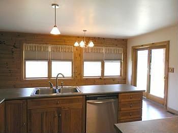 Kitchen overlooks dining area & access to back covered porch
