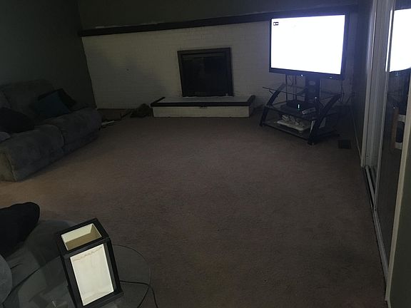 Family room with wood fire place and sliding doors out to the deck