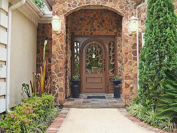 Now this is an impression! A gorgeous arched door with side lights and custom scroll work imported f
