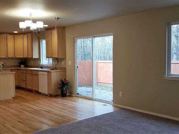 Kitchen with eating area and sliding door that leads to the back yard.