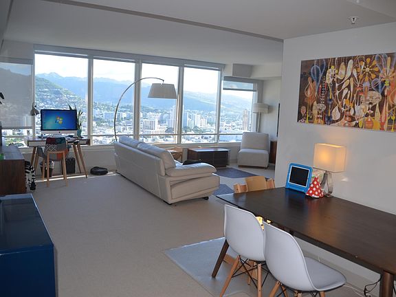 Living & dining room area..the furniture was from previous tenants. Living Room is now upgraded with wood floors. None of the furniture remains in the unit.