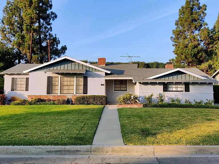 Front of house with large yard.