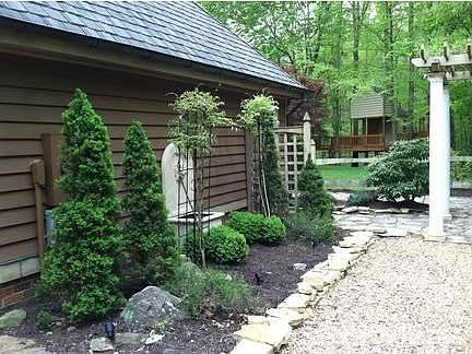Driveway Side Alpine Garden
						:
						Accent lighting and Lions Head water fountain