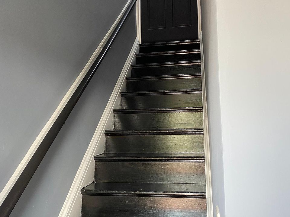 Entryway and stairs leading up to the apartment unit.