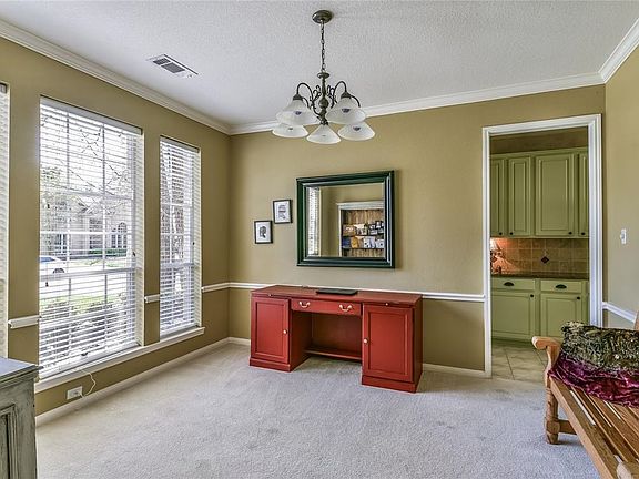 Formal Dining Room features chair rail and crown molding.