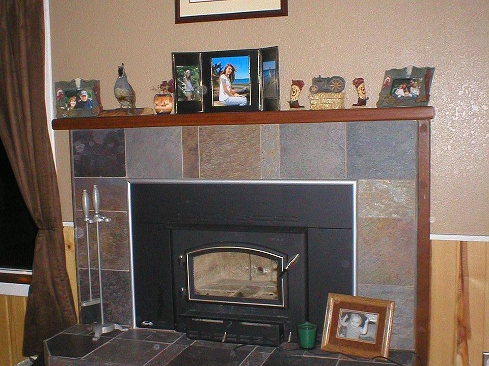 fireplace insert with slate surrounding it