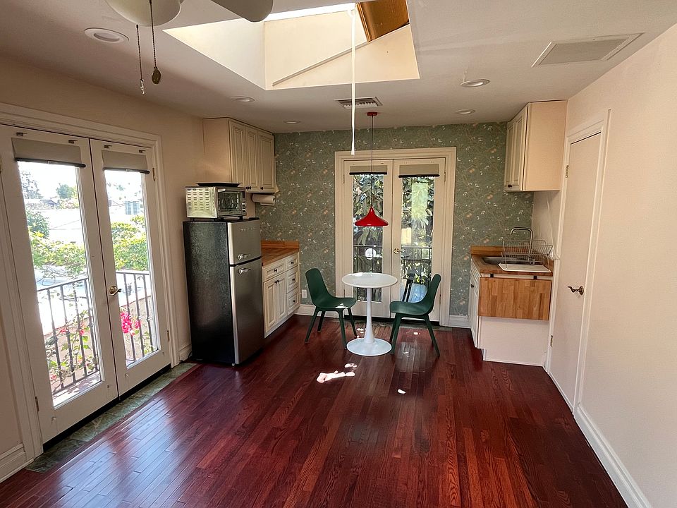 Living area and kitchenette with french doors to two small balconies.