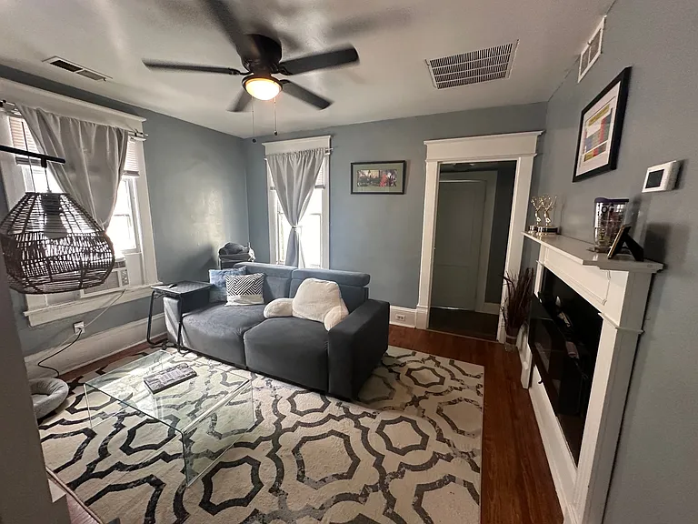 Previous Photo prior to new paint - Living Room w/ Designer Ceiling Fan and Two Large Windows for Natural Lighting!
*Apartment has been painted w/ Sherwin Williams French Gray!*