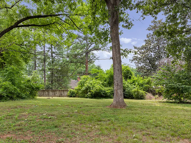 Fenced backyard is huge and flat with wonderful shade trees. You will love it here.