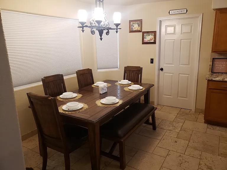 Indoor laundry with another refrigerator for additional space if needed.