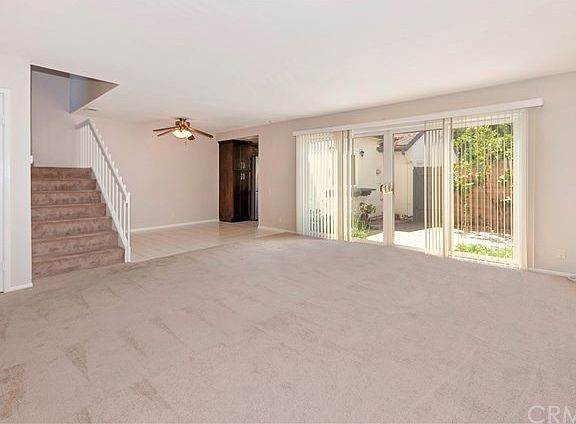 Huge living room, looking towards dining room and kitchen beyond. Double sliding doors to a very private enclosed patio.