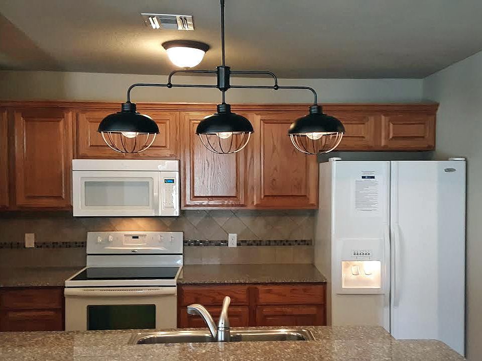 Kitchen with pantry, microwave, refrigerator with ice maker on the door, and plenty of storage!