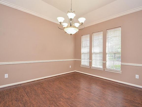 Elegant hardwoods and crow molding in the formal dining room.