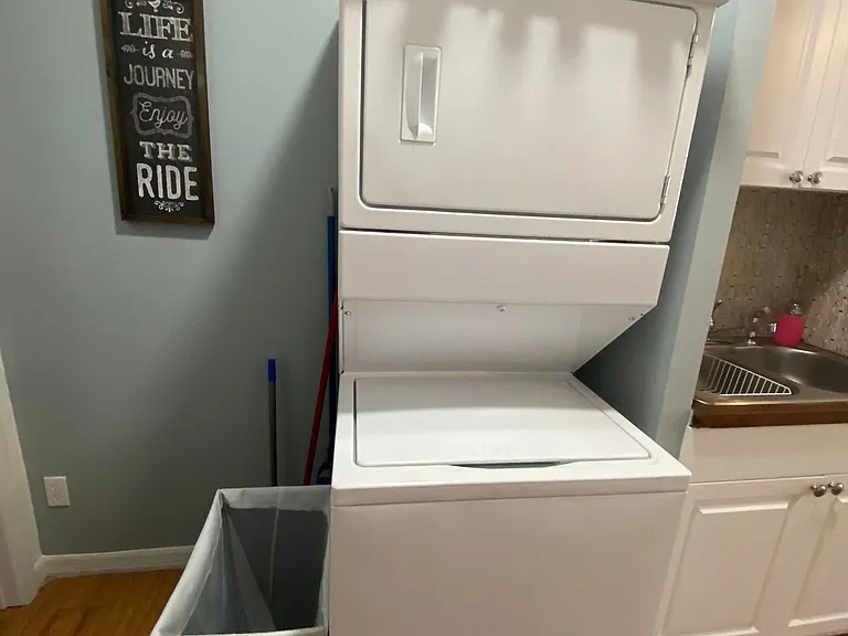 Laundry area has a bench and a washing machine