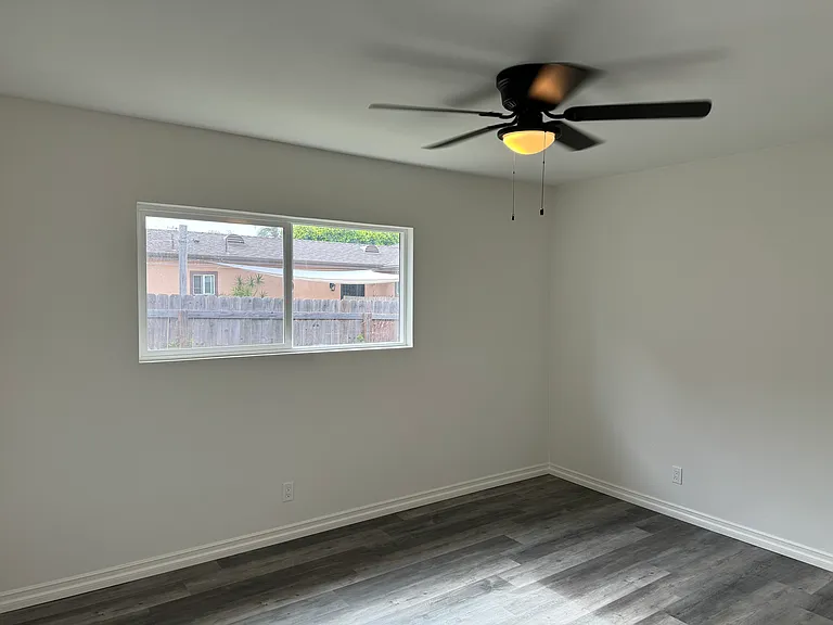 Bedroom 1 is good size with new closet doors, windows, flooring, and fan light.
