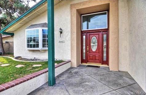 Enter through a beautiful beveled glass double wood door to a sp