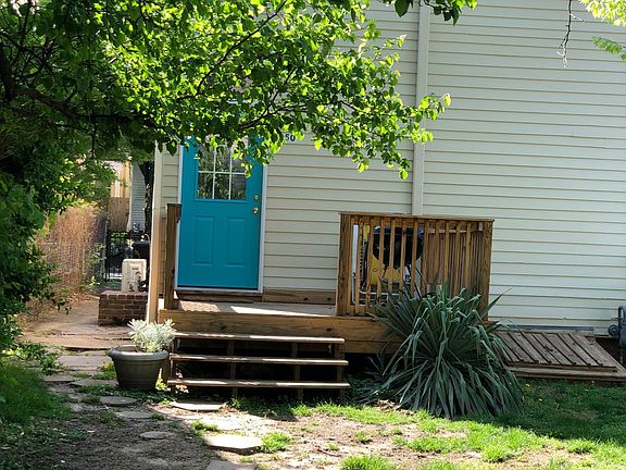 Apartment entrance. Small fenced yard with nice deck