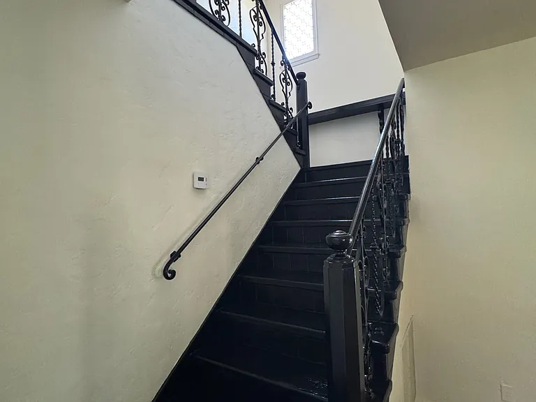 Staircase - original wrought-iron staircase with decorative railing.