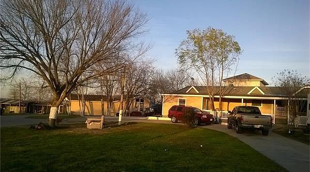 Front view: Round driveway, double wide (5/3) with single wide (2/1)